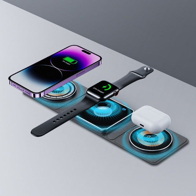 Wireless charging pad with smartphone, smartwatch, and earbuds on a gray surface