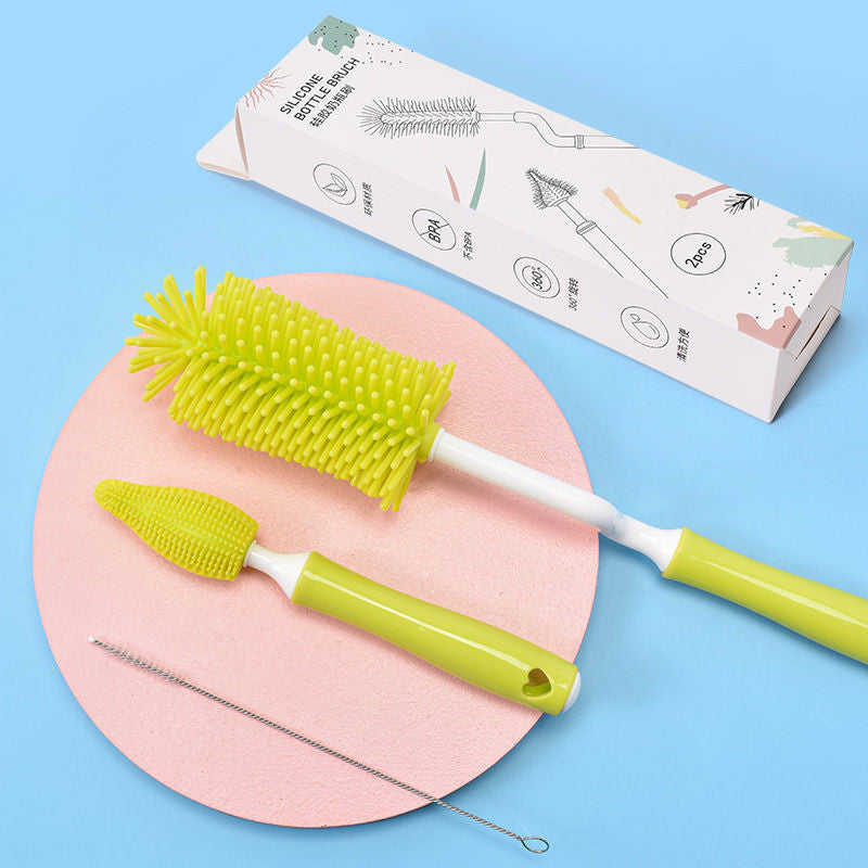 Green bottle cleaning brush set with packaging on a pink and blue background