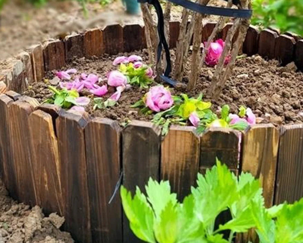 Wooden garden border with flowers and plants in a garden setting
