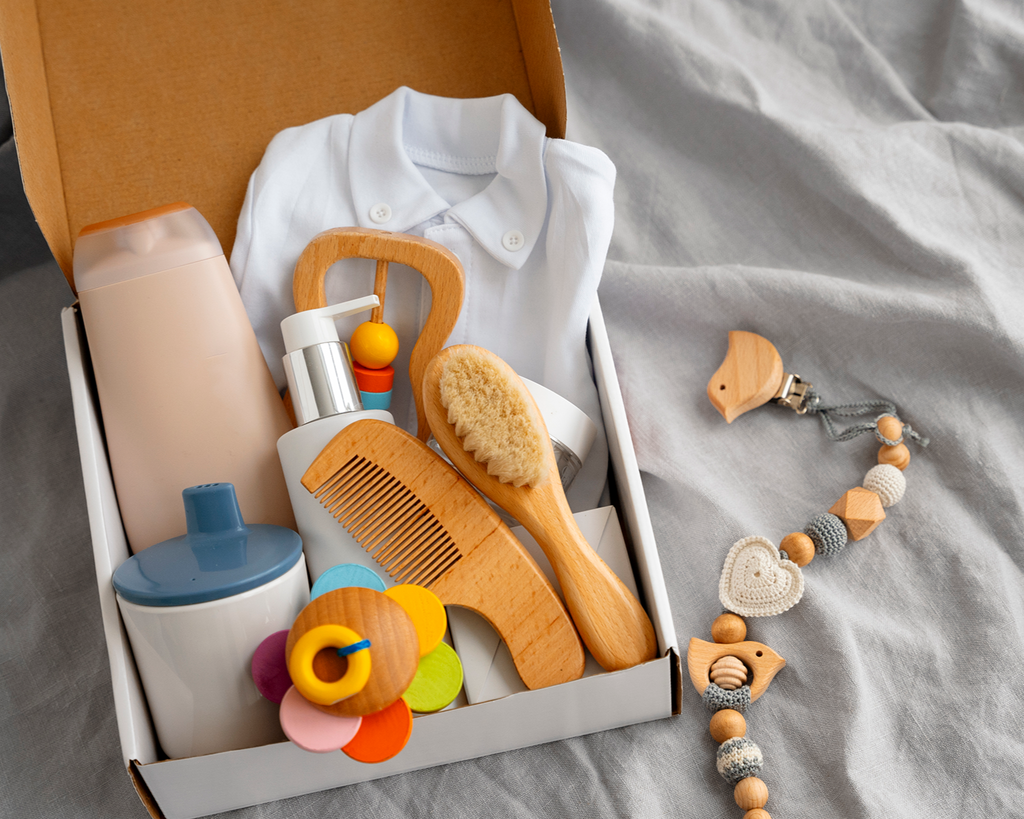 Collection of baby care items and toys on a gray surface